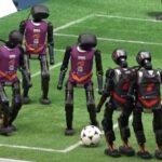 alt="In China's First AI Match, Robot Football Players Fight—Tumbles and Injuries Occur"