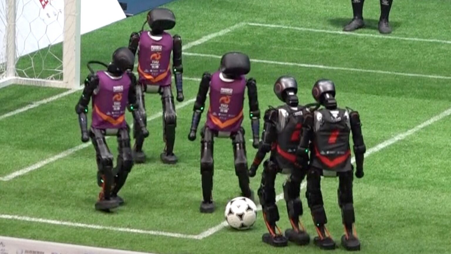 alt="In China's First AI Match, Robot Football Players Fight—Tumbles and Injuries Occur"