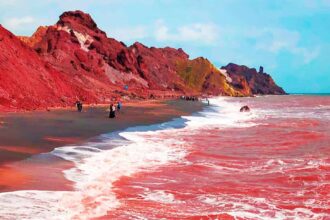 alt="rain-turns-irans-hormuz-island-seas-bright-red-in-surreal-natural-display"