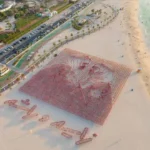 alt="uae-flag-portraits-of-zayed-and-rashid-fly-high-for-eid-al-etihad"